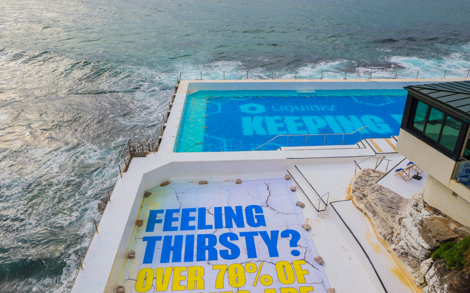 BONDI ICEBERGS POOL DRAINED & RE-HYDRATED BY LIQUID I.V. TO RAISE AWARENESS OF AUSSIES’ DEHYDRATION_3 (1) Giant Liquid IV advert at Bondi Iceberg Pools.